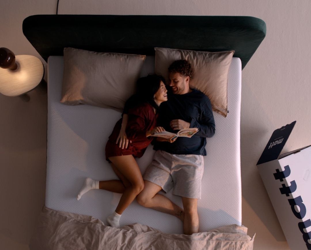Still uit de TVC: een stel van bovenaf in bed